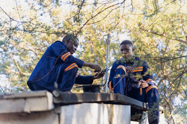 African technicians installing network cabling infrastructure