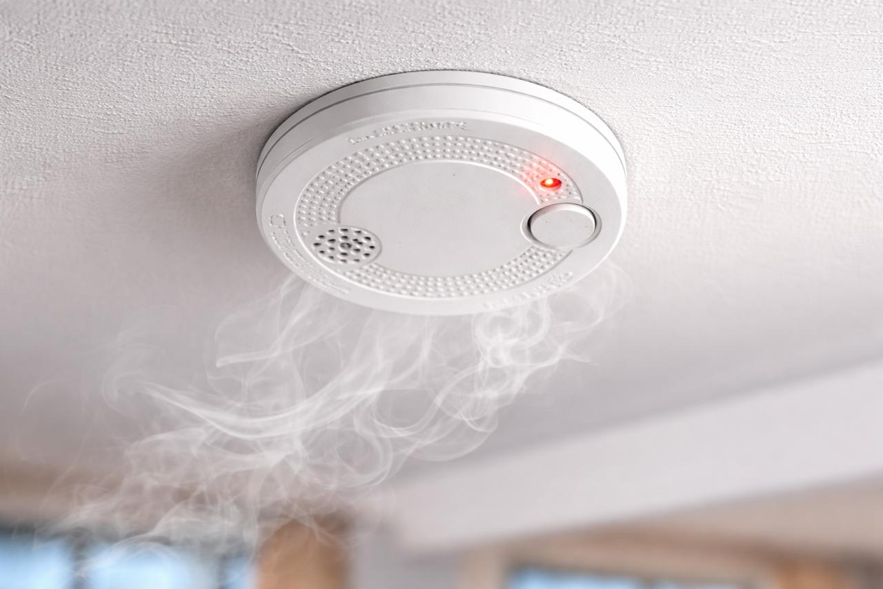 Smoke detector on ceiling detecting smoke for early fire warning by Isys Technologies